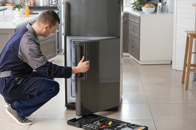 Professional defrosting of manual freezer in Dubai showing ice removal and maintenance best practices