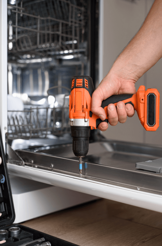 Noisy dishwasher repair showing technician diagnosing grinding sounds in Dubai home dishwasher