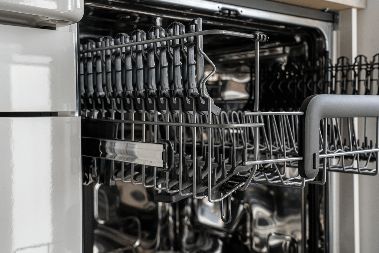 Dishwasher repair for cleaning issues showing dirty dishes and clogged spray arms in Dubai kitchen