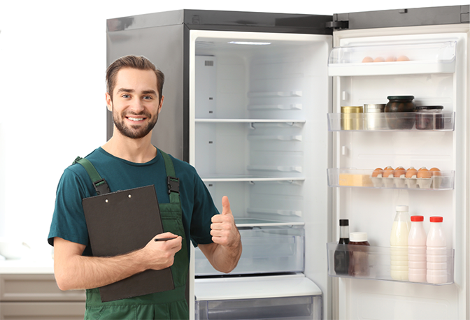 Certified refrigerator repair technician in Dubai checking Samsung refrigerator compressor with professional diagnostic equipment