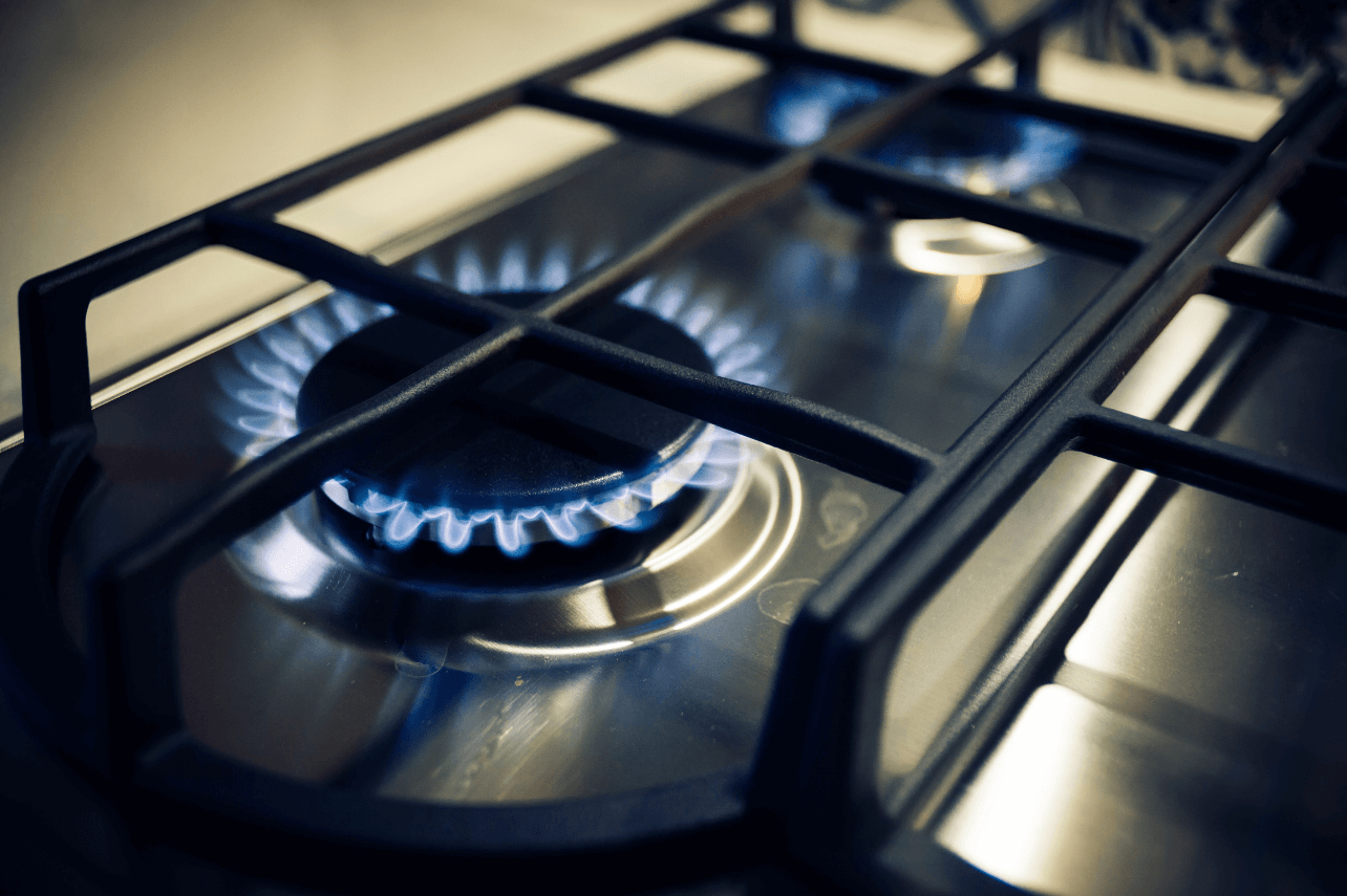 Certified cooking range repair technician in Dubai inspecting a faulty gas stove burner with professional diagnostic equipment