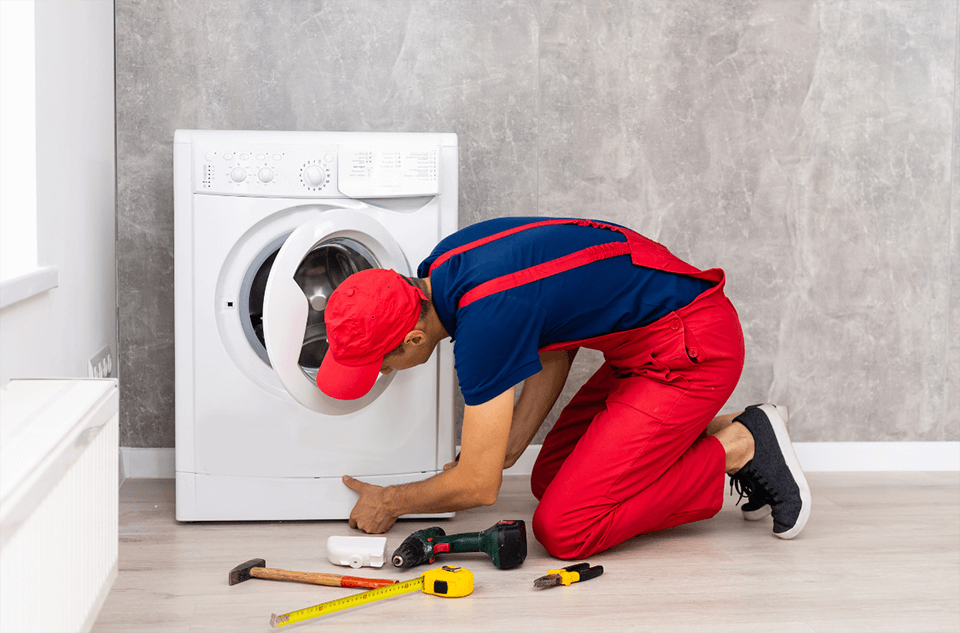 Washing machine repair expert fixing water leakage issue from front-load washer in Dubai apartment