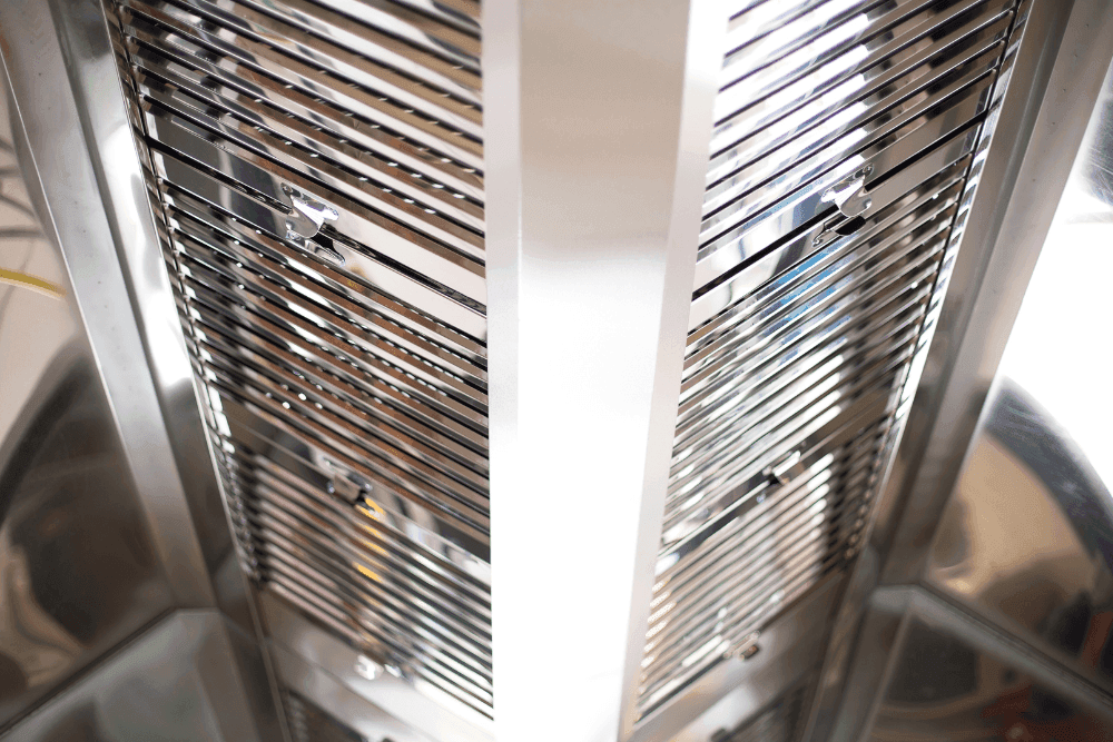 Stainless steel baffle filters inside a commercial kitchen extraction hood